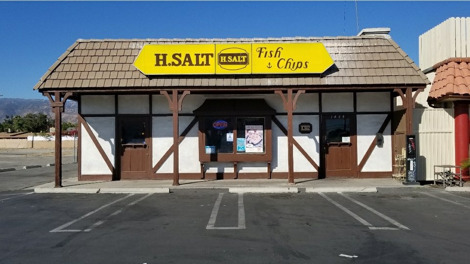 A fast-food seafood meal with fried sides.