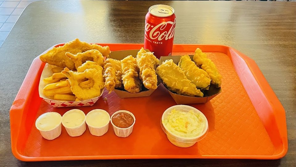 Menu board listing fish and chips meal options.