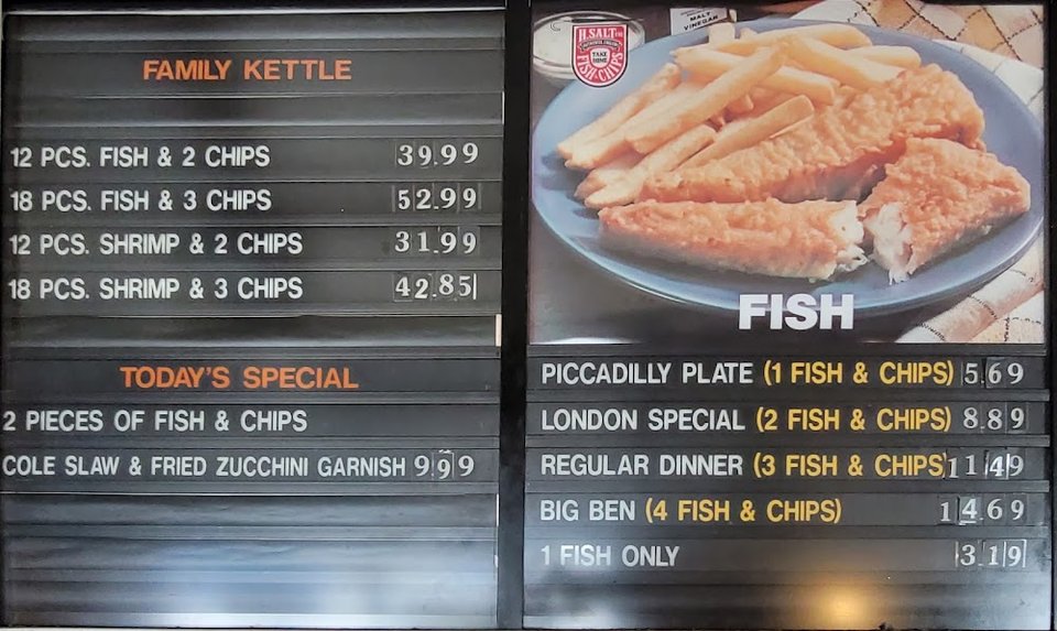Menu board listing fish and chips meal options.